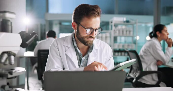 Tablet, scientist or man with laptop for medical experiment, results or innovation in lab at night. Microbiology, biotechnology or science professional with research study, cure development or scroll
