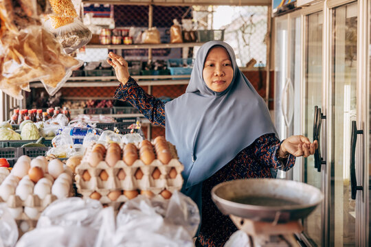 Kvinnlig livsmedelshandlare st&aring;r i butik