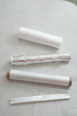 Rolls of various plastic packaging for food products. Bags in a roll, food film, baking sleeve.