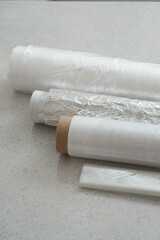Rolls of various plastic packaging for food products. Bags in a roll, food film, baking sleeve.