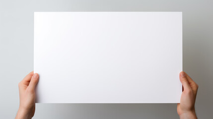 Hand holding blank paper on white background