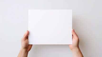 Obraz premium Hand holding blank paper on white background