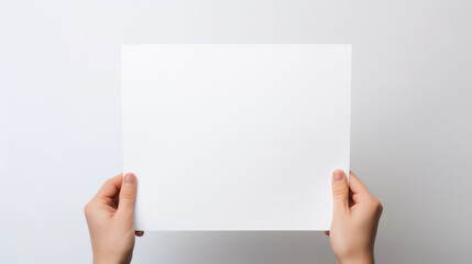 Obraz premium Hand holding blank paper on white background