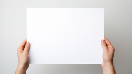 Hand holding blank paper on white background
