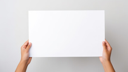 Hand holding blank paper on white background