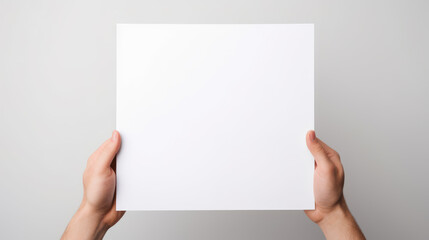 Obraz premium Hand holding blank paper on white background
