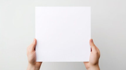 Obraz premium Hand holding blank paper on white background