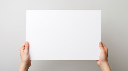 Hand holding blank paper on white background