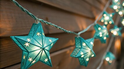 Close-up of glowing teal star-shaped string lights hanging on a wooden wall, ideal for cozy outdoor or festive decoration.