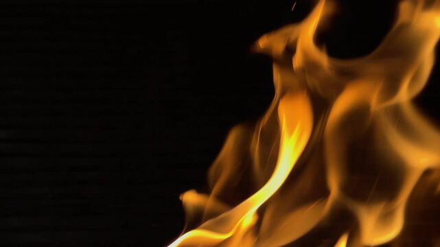 Fire dancing in slow motion on black background. close up.