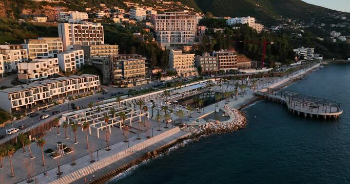 Amazing bird's-eye view of Vlore, Albania, featuring the waterfront at sunset. The shot highlights the beautiful coastal landscape and striking hotel architecture, capturing the essence of the city.