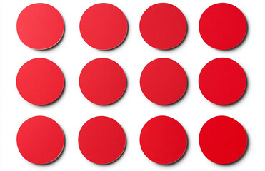 Arrangement of twelve red circular objects displayed on a plain white surface with soft shadows