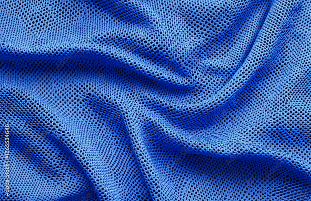 Poster close up of a wrinkled blue mesh fabric showing its texture and pattern with dark background showing