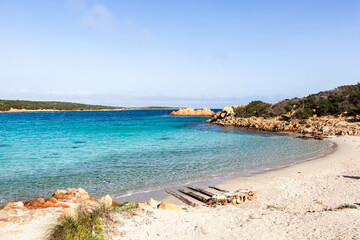 Caprera island in Maddalena Archipelago, Sardinia, Italy. Sandy beach and gorgeous crystal clear turquoise blue Mediterranean sea. Beautiful Seascape.