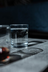 Close up pouring purified fresh drink water from the bottle on table in living room