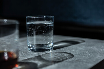 Close up pouring purified fresh drink water from the bottle on table in living room