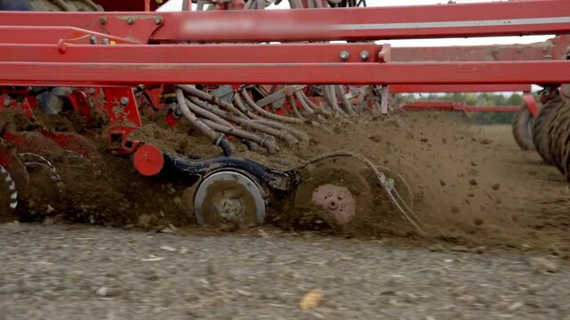 Close-Up Of Precision Air Seeder Disc Openers Cutting Soil While Planting Crops