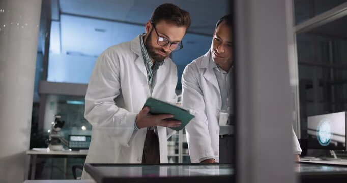 Scientist, men and meeting with tablet in laboratory for pharmaceutical review, medical research or innovation. Night, people and clinical analysis for studying science data, teamwork and results