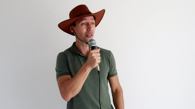 homem com chap&eacute;u usando microfone para discurso 