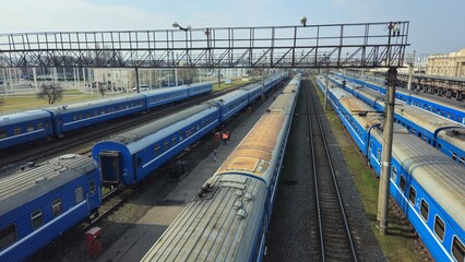 Naklejka premium Blue trains parked at a railway yard on a bright day