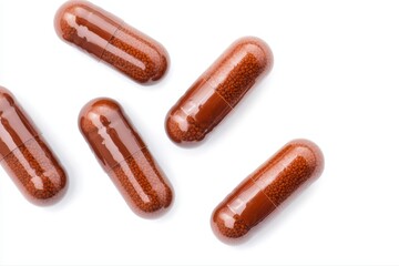 Brown capsules with beads on white surface