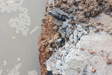 Close-up view of cracks in road under construction.