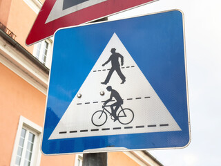 Bicycle and pedestrian traffic warning sign in urban setting