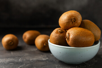 Kiwi on wooden background. Whole fruit and slices pieces of green kiwi on table. fresh ripe juicy...