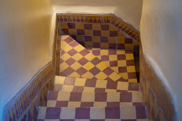 Authentic Moroccan riad interior with checkerboard tiled steps, Traditional riad interior in...