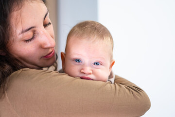 Loving mother embracing her infant child