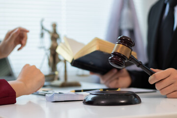 Cooperation in providing good service and consultation between a male lawyer and a female business client shaking hands after an agreement at a law firm.