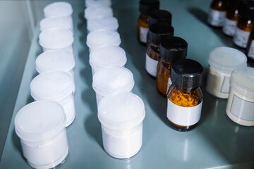 Shelf storage facility stocked with products of organized pill bottles in a modern sterile medicine...