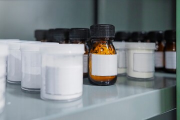 Shelf storage facility stocked with products of organized pill bottles in a modern sterile medicine...