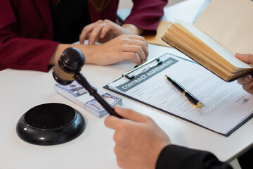 Cooperation in providing good service and consultation between a male lawyer and a female business client shaking hands after an agreement at a law firm.