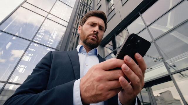 Mobile phone connection problem lost Wi-Fi broken smartphone entrepreneur near office angry upset with cellphone trouble online connect Caucasian man businessman guy male business in city bad signal - Powered by Adobe