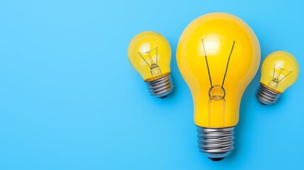 Three Yellow Light Bulbs on Light Blue Background Representing Creativity and Ideas