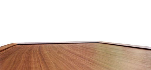 close-up view of a polished wooden teak table edge, with blurred greenery and outdoor furniture in...