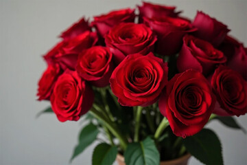 A passionate bouquet of deep red roses, a symbol of enduring love and romance, softly lit against a neutral background.