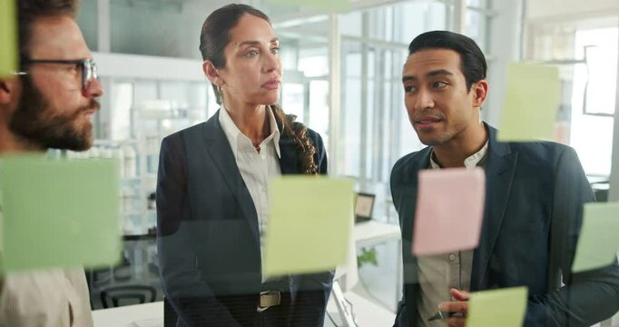 Woman, men and planning by glass with team, feedback or mind map for problem solving at startup. Business people, question and group by board for discussion, notes or strategy for solution at company