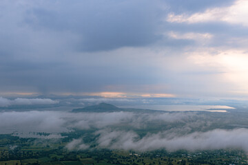 Cloudscape at Dawn: A serene and expansive landscape unfolds as a bank of clouds blankets the scenery. A peaceful scene that captures the beauty and tranquility of nature. 