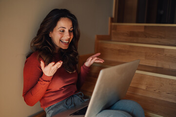 Happy freelancer woman working from home having a video call on her laptop