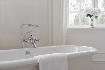 Modern elegant minimalist bathroom interior with curtains and window and freestanding bathtub. Home...