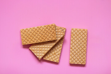 Waffles on a smooth pink background. perfect for illustrating a minimalist breakfast or dessert idea.