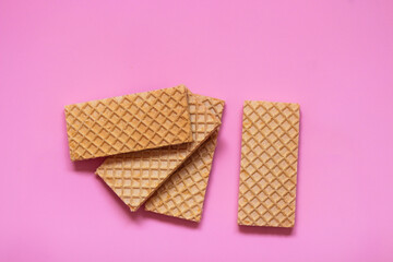 Waffles on a smooth pink background. perfect for illustrating a minimalist breakfast or dessert idea.