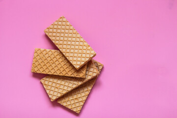 Waffles on a smooth pink background. perfect for illustrating a minimalist breakfast or dessert idea.