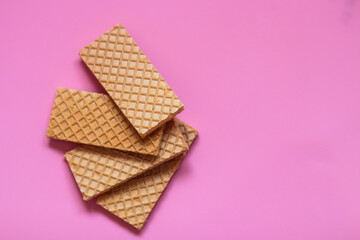 Waffles on a smooth pink background. perfect for illustrating a minimalist breakfast or dessert idea.