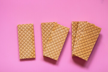 Waffles on a smooth pink background. perfect for illustrating a minimalist breakfast or dessert idea.