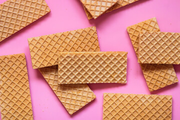 Waffles on a smooth pink background. perfect for illustrating a minimalist breakfast or dessert idea.