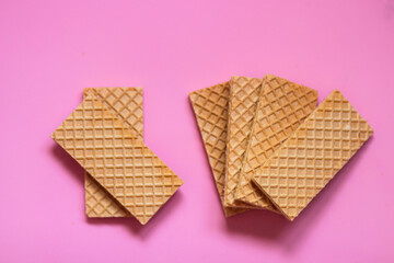 Waffles on a smooth pink background. perfect for illustrating a minimalist breakfast or dessert idea.