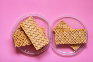 Waffles on a smooth pink background. perfect for illustrating a minimalist breakfast or dessert idea.